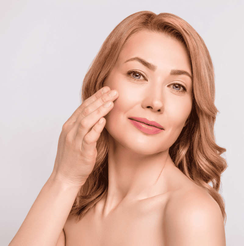 Portfolio 10 Photo portrait woman after shower naked shoulders applying night age face cream isolated white color background copyspace | Glam Bar Medical Spa in Los Angeles CA